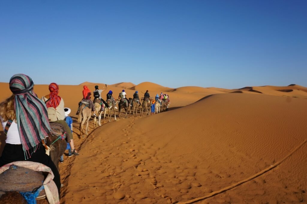 Camel trekking Sahara desert Morocco adventure holiday experience